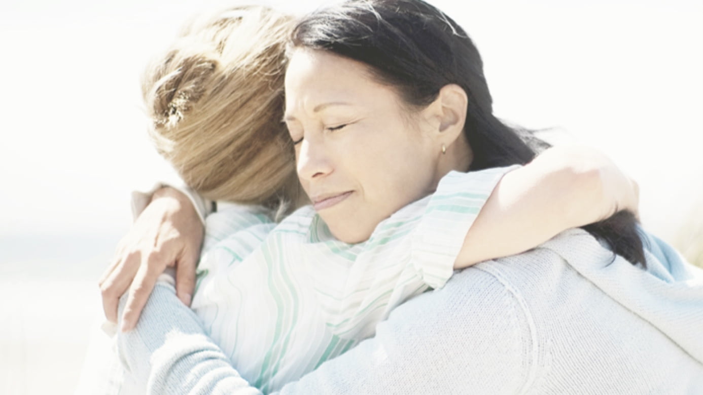 Two individuals hugging