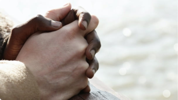 Hands resting on a bannister 